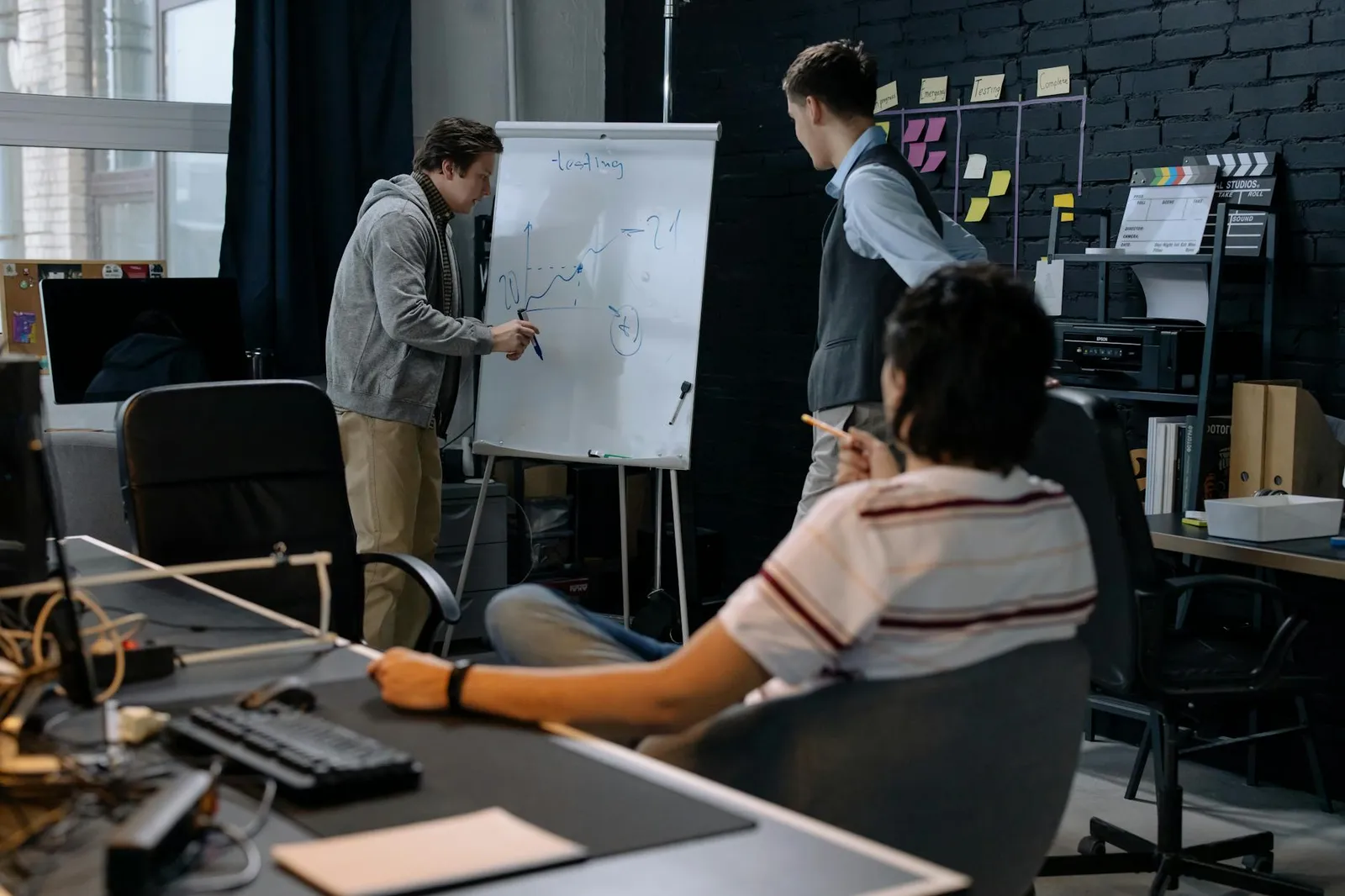 Consultants mapping a business process on a whiteboard