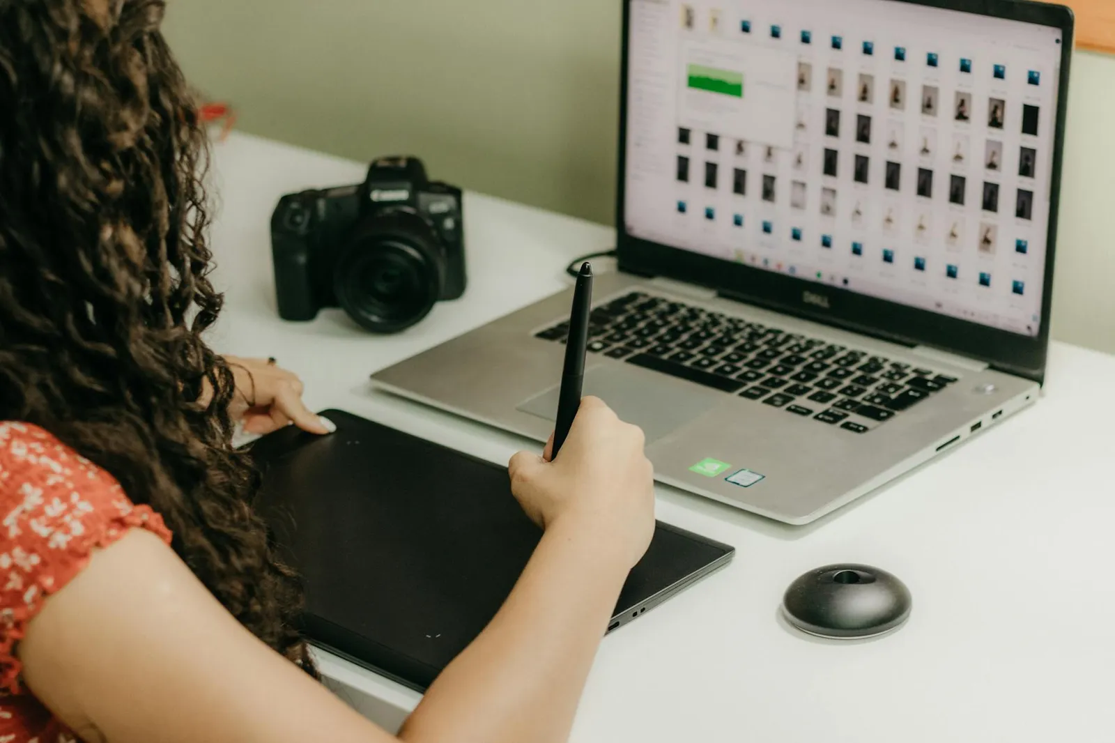 Person carefully reviewing a laptop workflow