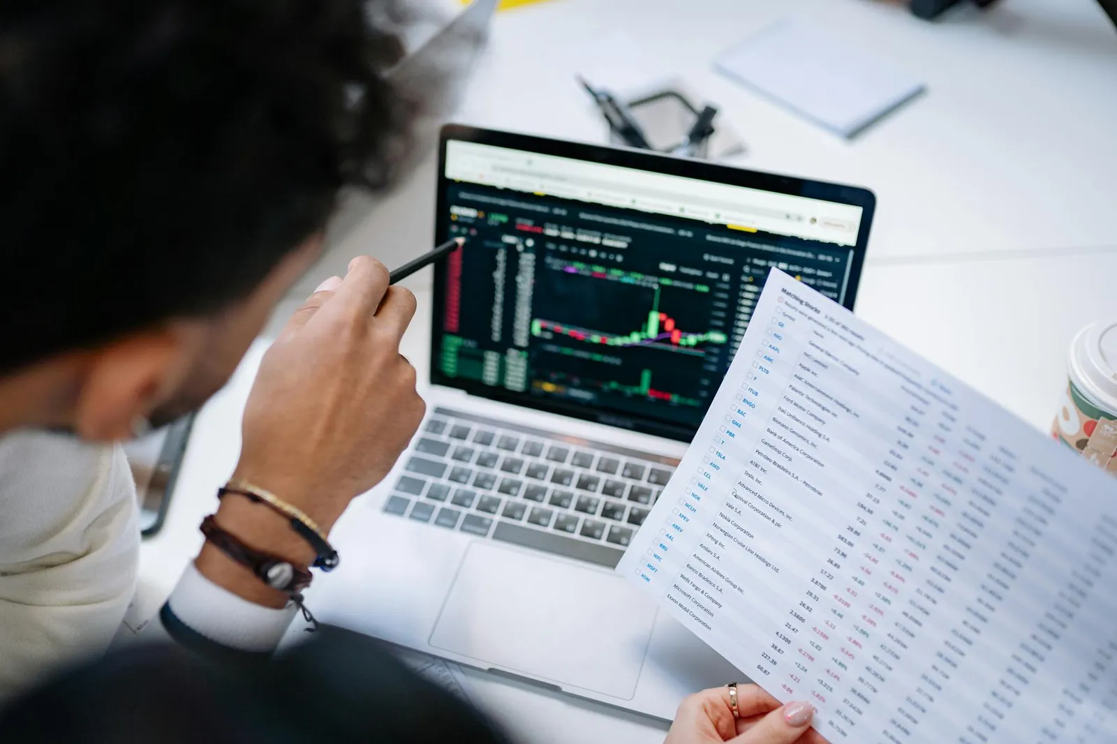 Finance documents and laptop representing an offline budget processing workflow.